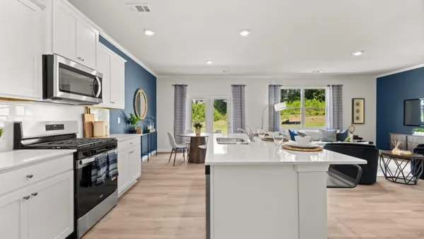 a large kitchen with stainless steel appliances lots of counter top space