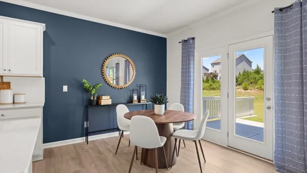 a dining room with furniture and a window
