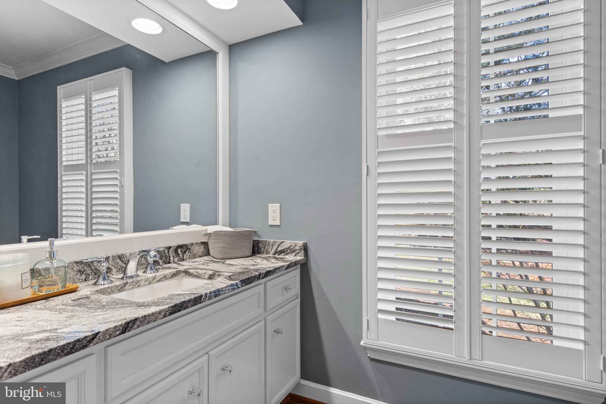 205 Ravenscliff Road Wayne, PA 19087 - Photo 31 of 65 a bathroom with a granite countertop sink and a window