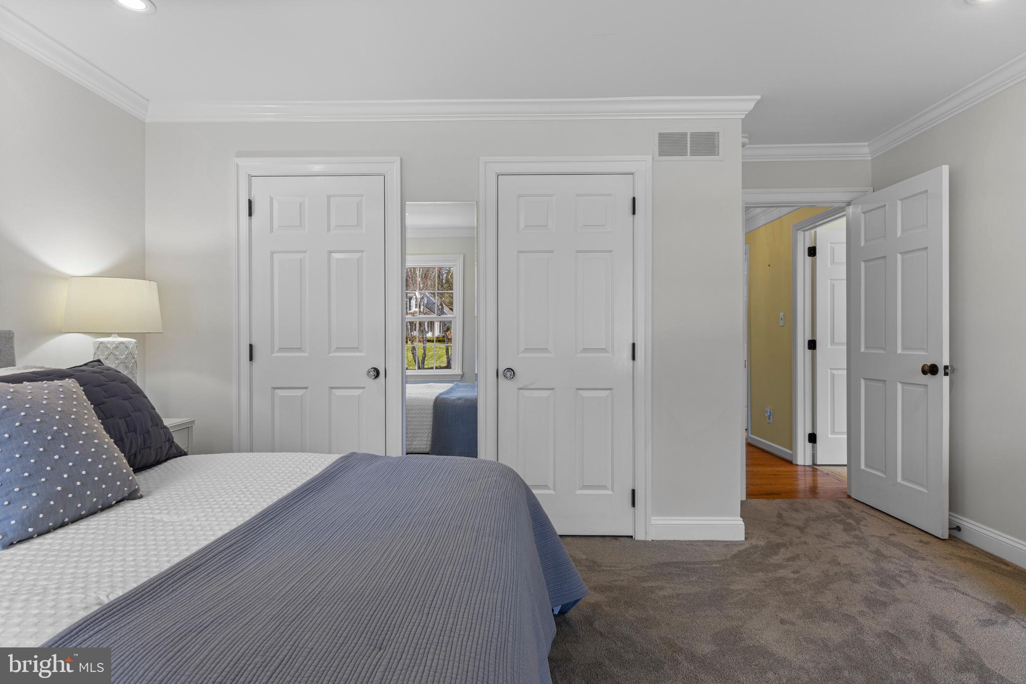 205 Ravenscliff Road Wayne, PA 19087 - Photo 43 of 65 a bedroom with a bed and a lamp