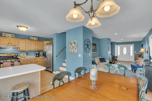 a kitchen with stainless steel appliances a stove a sink and a refrigerator