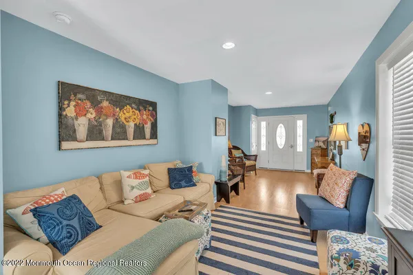 a living room with furniture a couch and wooden floor