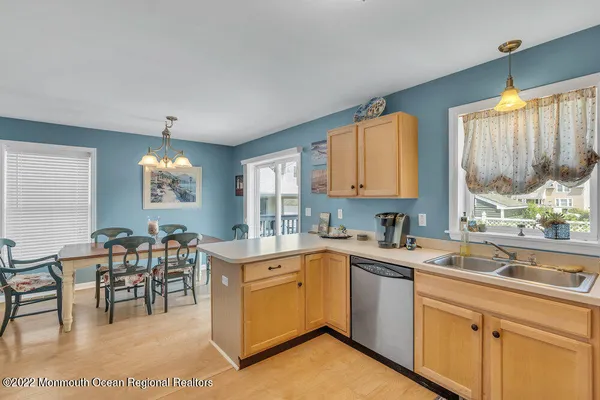 a kitchen with a sink window and cabinets