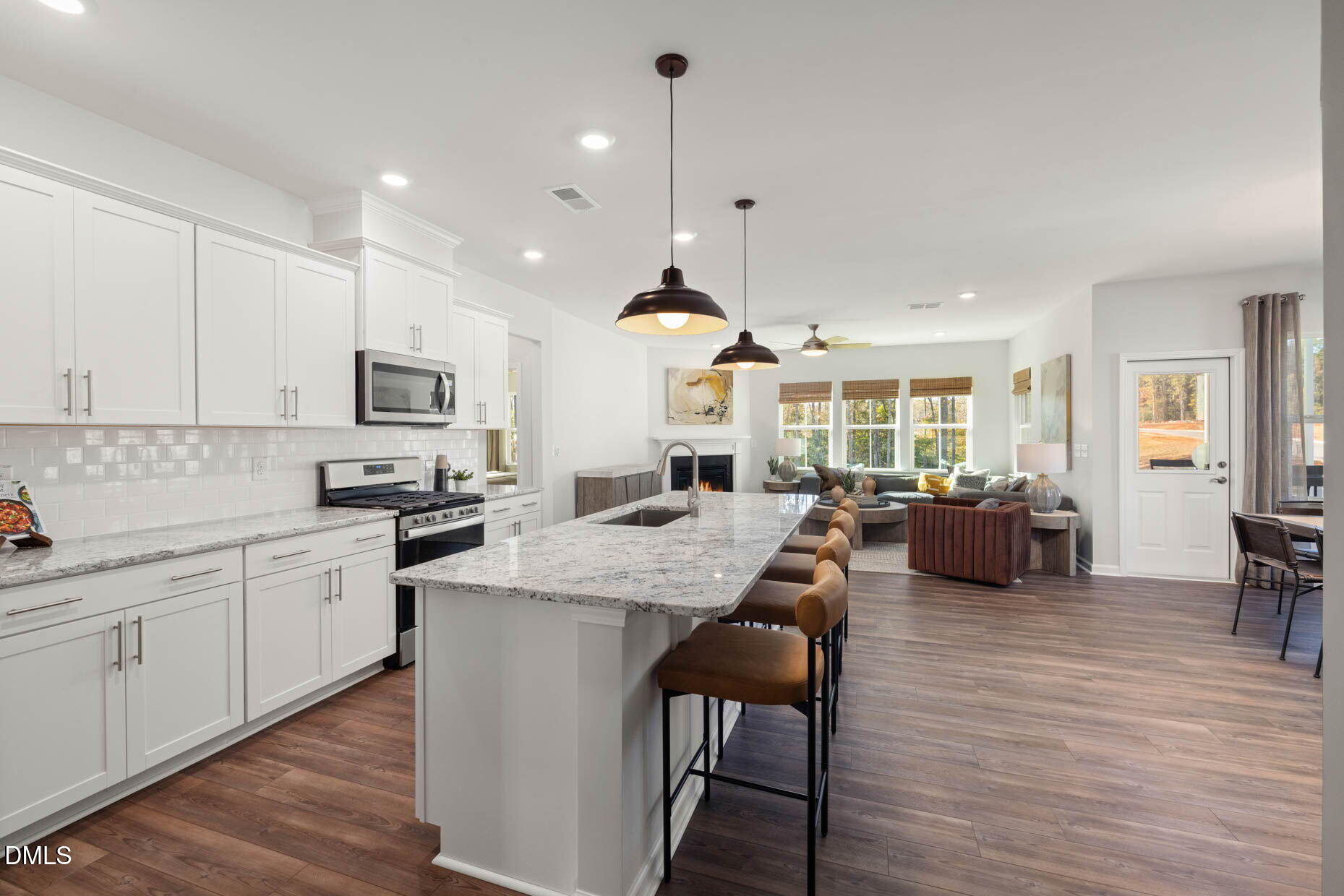 360 Broomside Avenue Raleigh, NC 27603 - Photo 2 of 35 a large kitchen with white cabinets a sink dishwasher and a stove with wooden floor