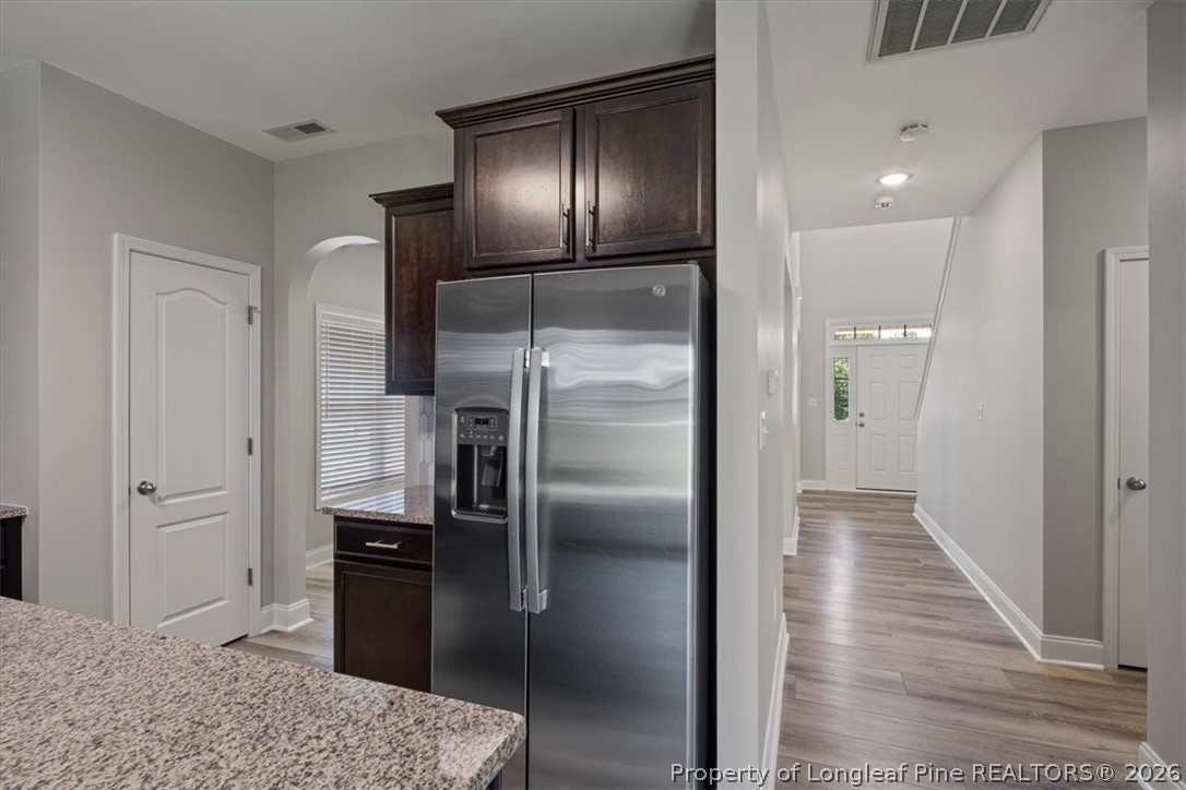 134 Huzzas Circle Cameron, NC 28326 - Photo 8 of 31 a kitchen with stainless steel appliances kitchen island a refrigerator and a sink