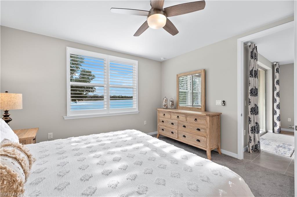 14558 Edgewater Circle Naples, FL 34114 - Photo 13 of 40 a bedroom with a bed and a window