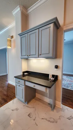 a kitchen with granite countertop a sink cabinets and stainless steel appliances