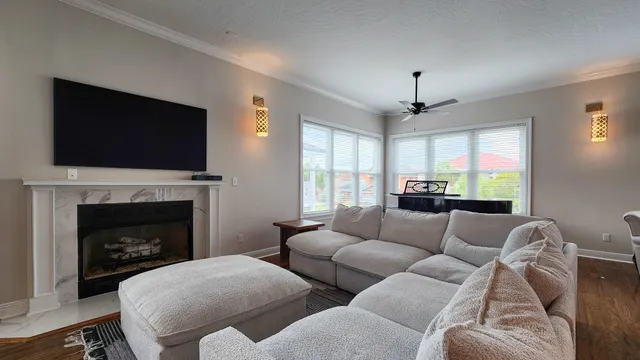 a living room with furniture a flat screen tv and a fireplace