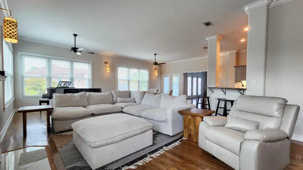 a living room with furniture and a chandelier