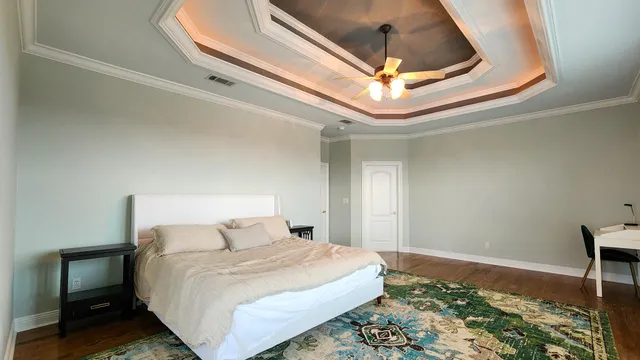 a bedroom with a bed and a dresser