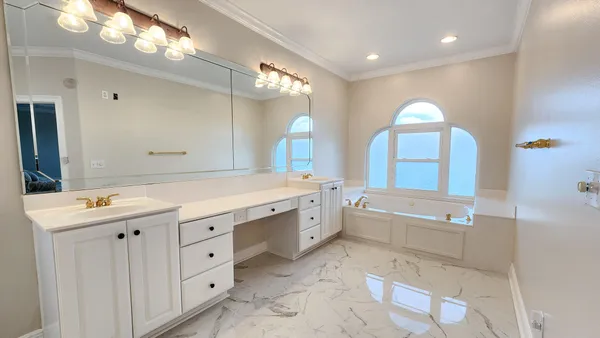a bathroom with a double vanity sink mirror and shower