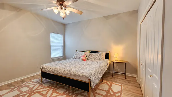 a bedroom with a bed and a chandelier