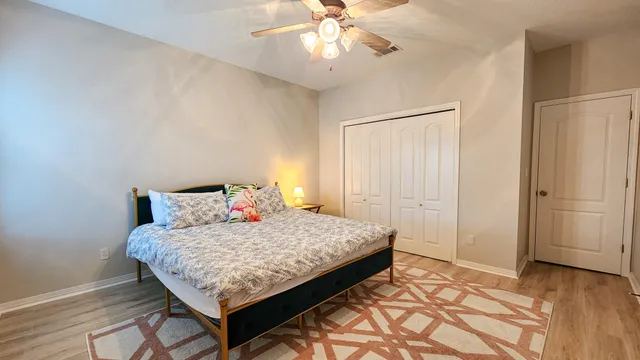 a bed sitting in a bedroom next to a window