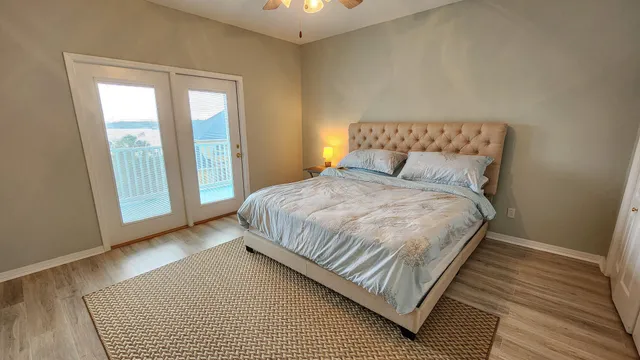a bedroom with a bed and wooden floor