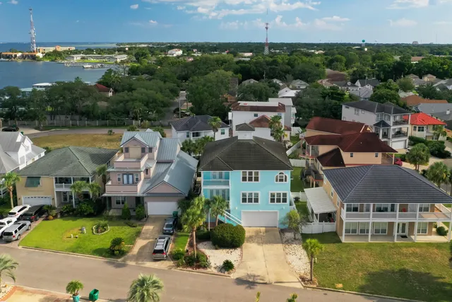 an aerial view of multiple houses with a yard