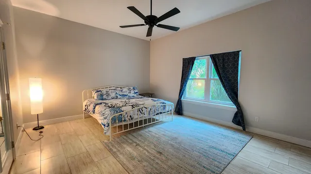 a bedroom with a bed and a window
