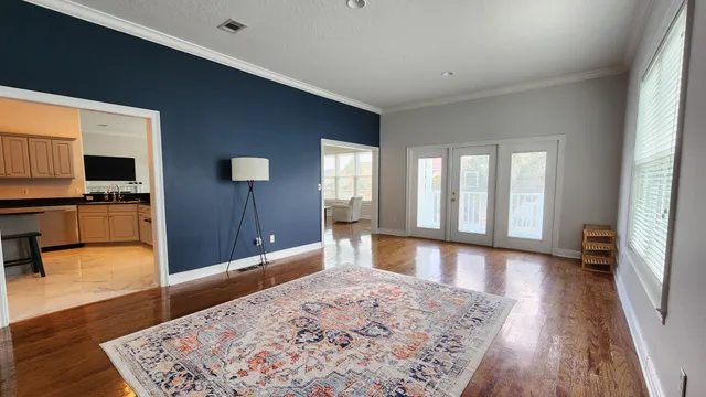 a view of a large kitchen with wooden floor and a sink