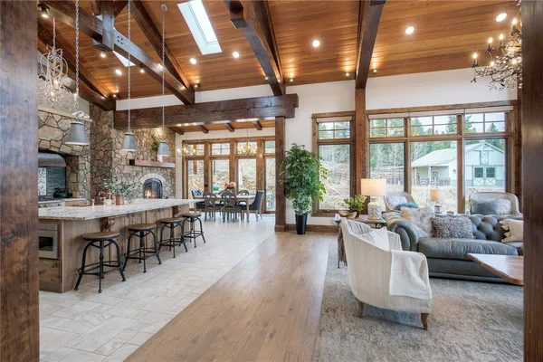 a living room with furniture a fireplace and a large window