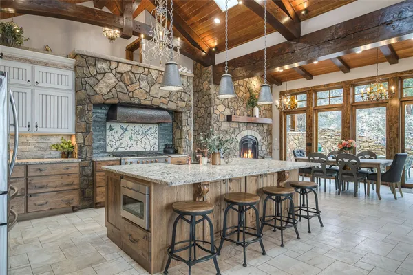 a kitchen with stainless steel appliances granite countertop a refrigerator and a sink