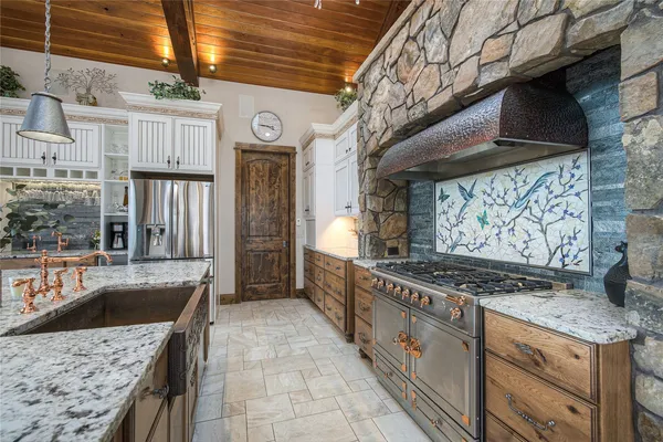 a kitchen with stainless steel appliances granite countertop a sink and a counter top space