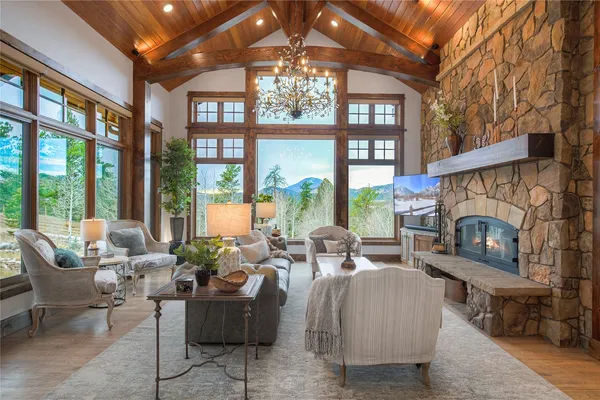 a living room with furniture and a floor to ceiling window