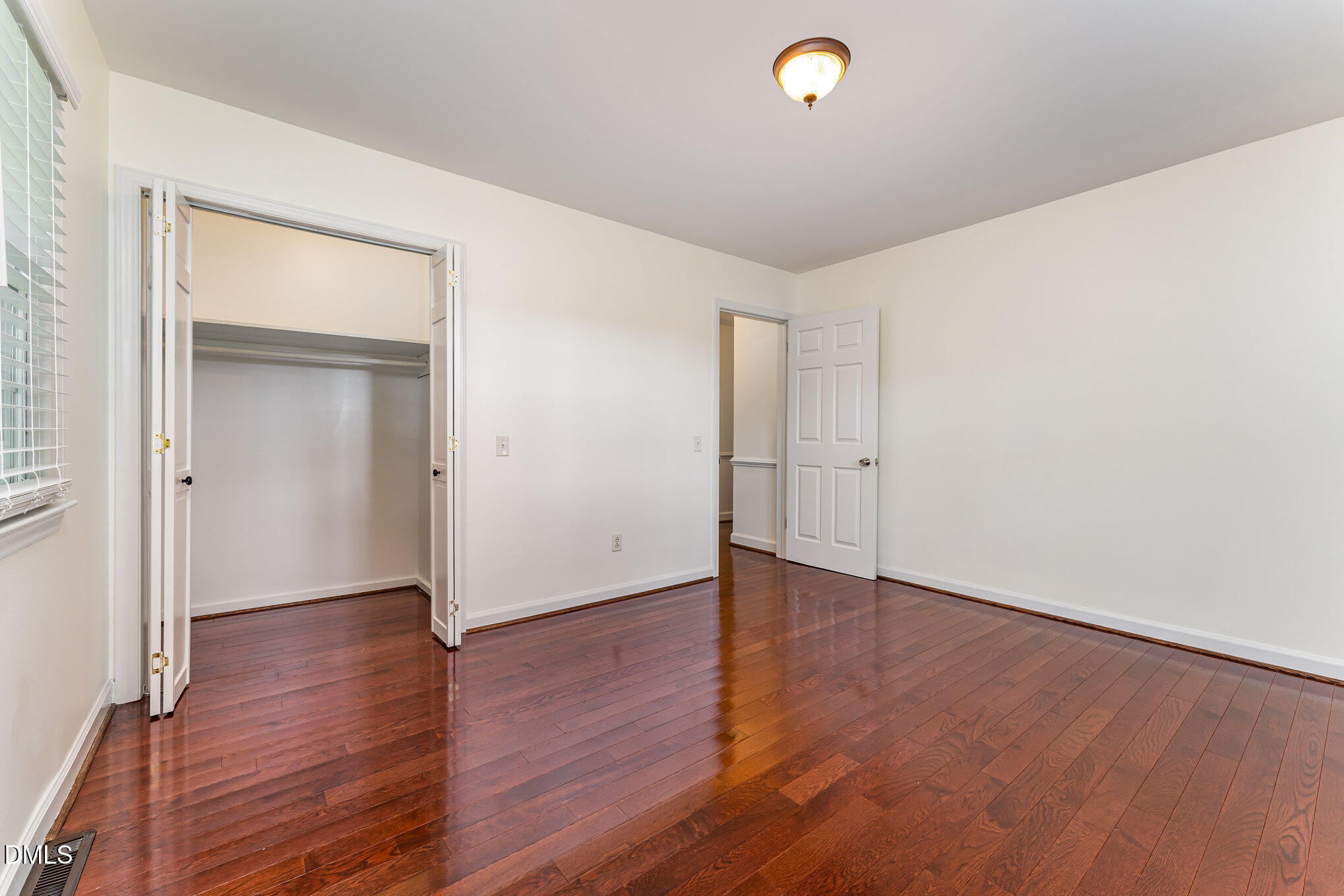9670 Valley Road Middlesex, NC 27557 - Photo 14 of 22 a view of an empty room with wooden floor and a window