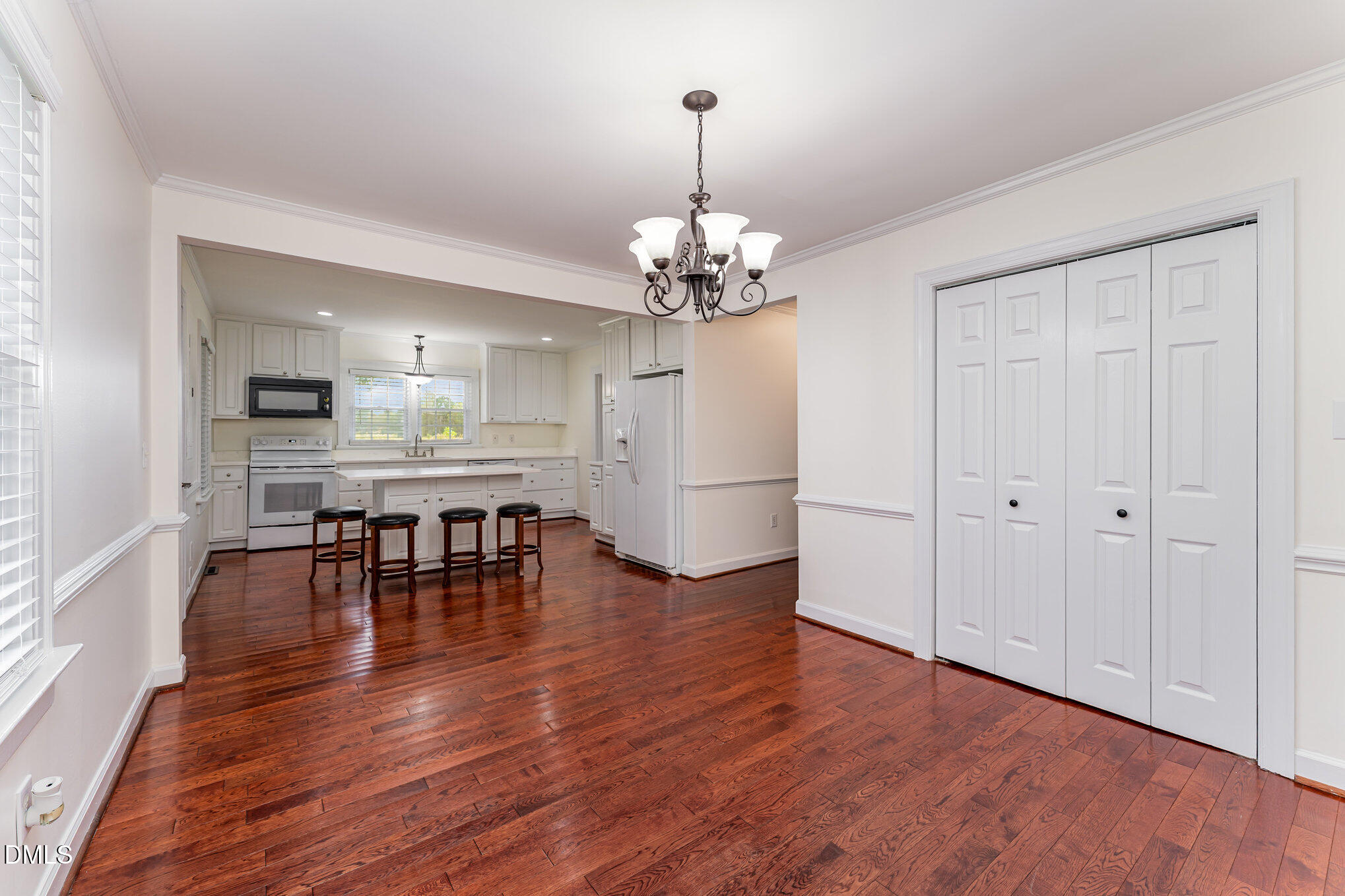 9670 Valley Road Middlesex, NC 27557 - Photo 6 of 22 a dining room with wooden floor a chandelier a glass table and chairs