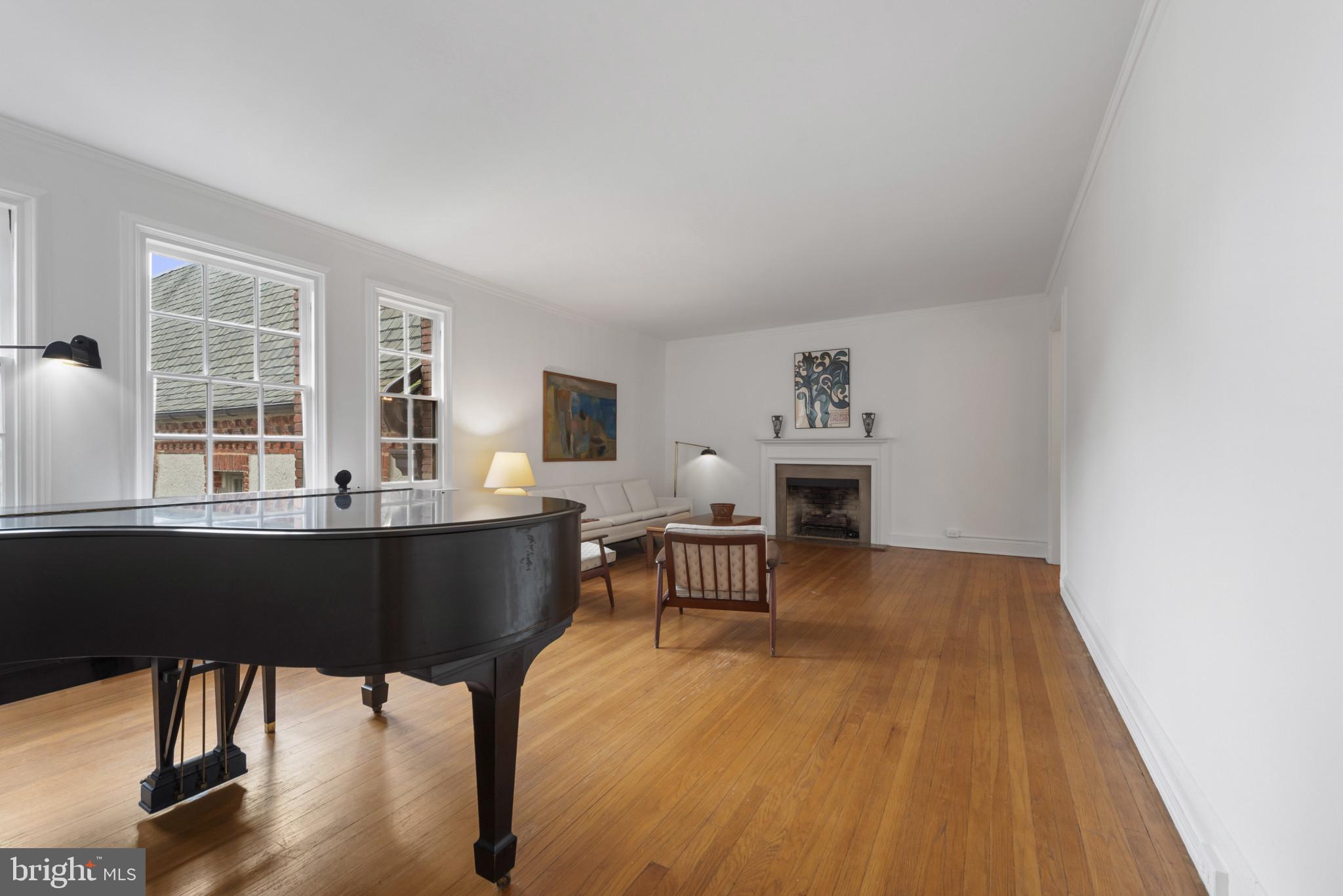 6 Upland Road, Unit F5 Baltimore, MD 21210 - Photo 17 of 31 a living room with furniture a fireplace and large windows