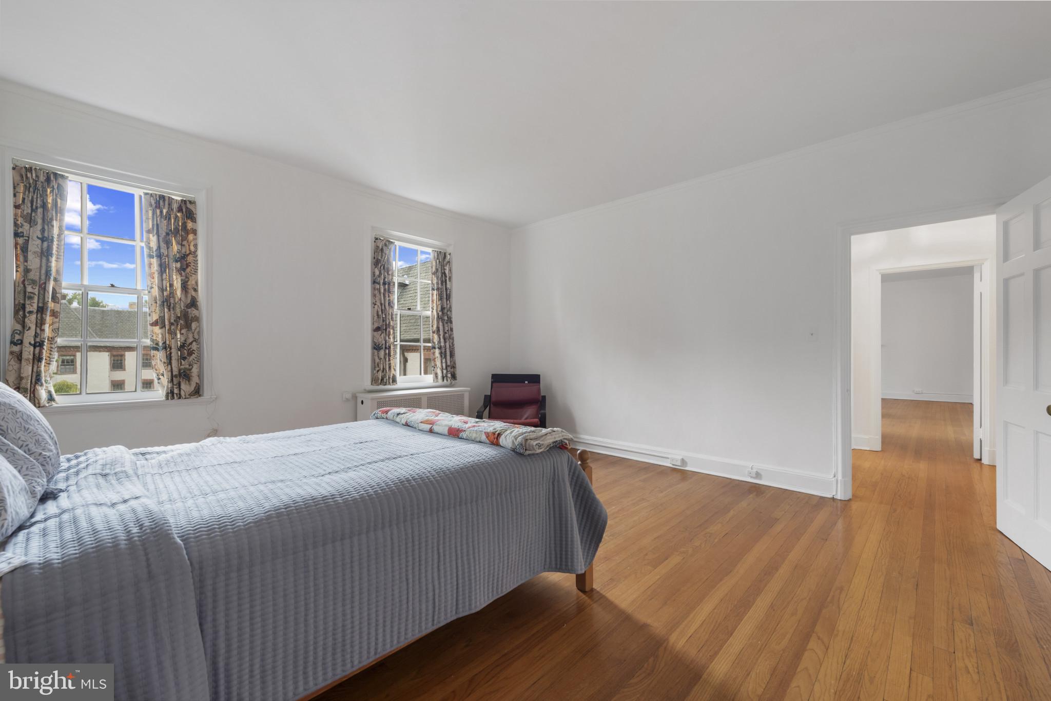 6 Upland Road, Unit F5 Baltimore, MD 21210 - Photo 20 of 31 a bedroom with a bed and wooden floor