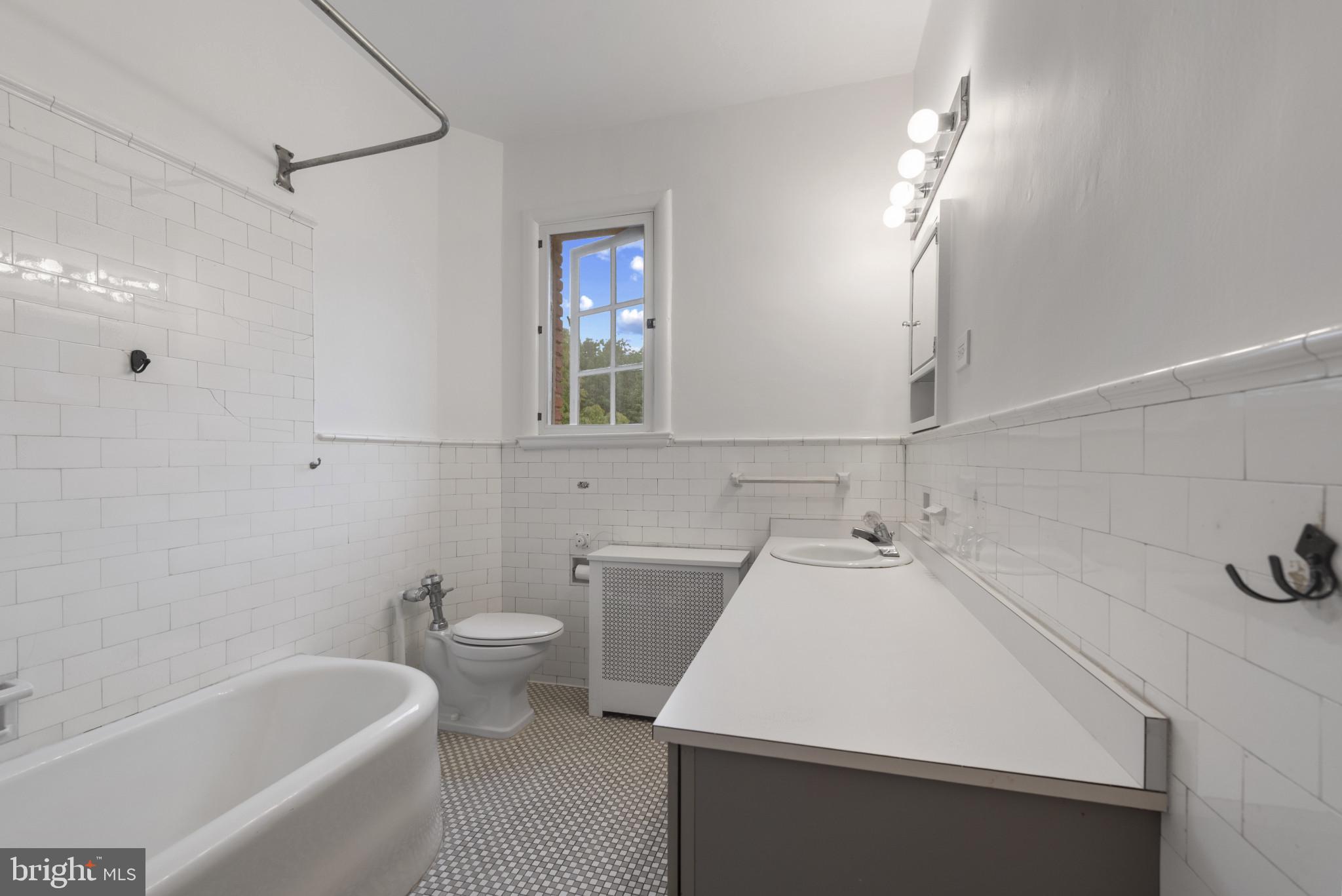 6 Upland Road, Unit F5 Baltimore, MD 21210 - Photo 22 of 31 a bathroom with a sink a toilet and shower