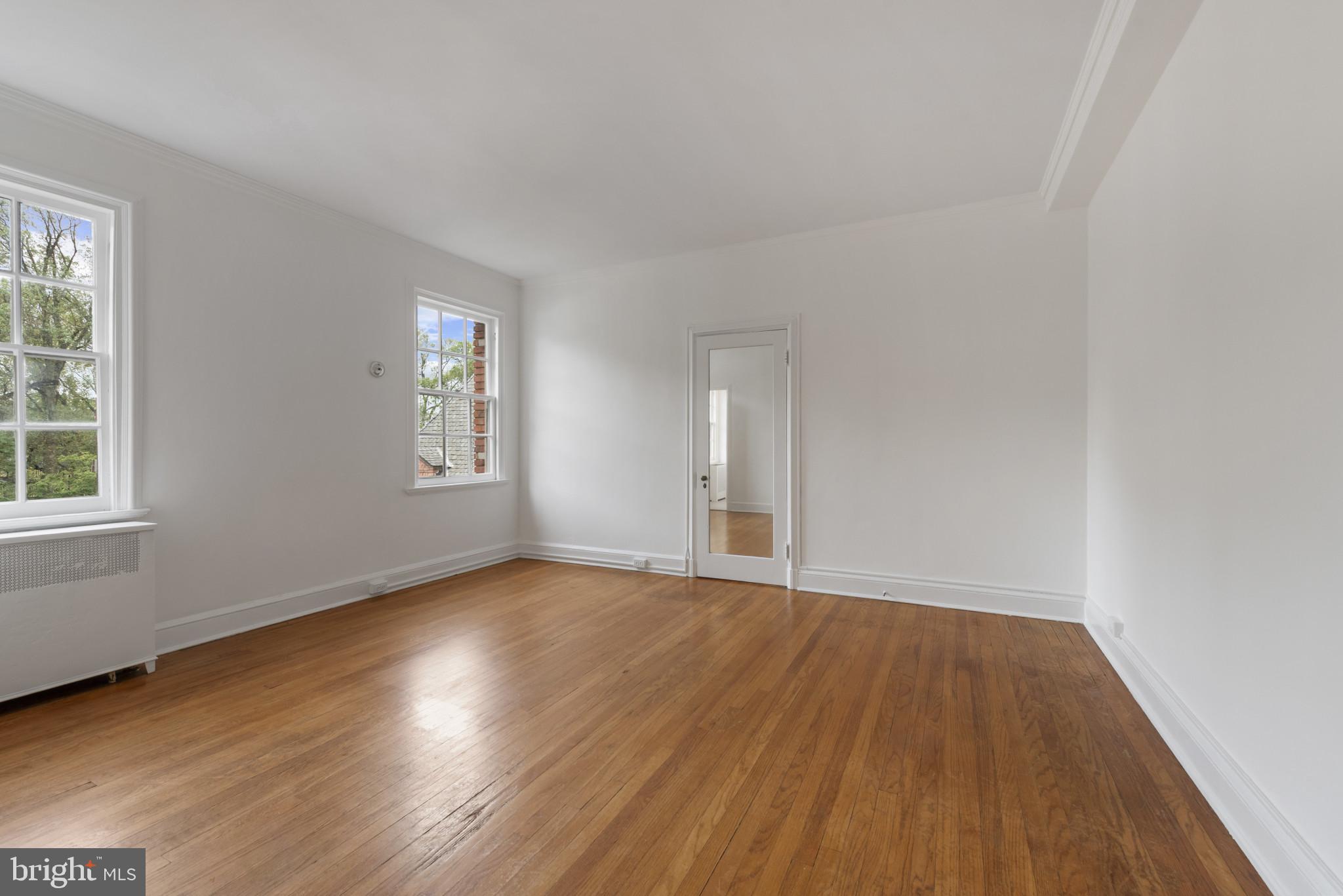 6 Upland Road, Unit F5 Baltimore, MD 21210 - Photo 24 of 31 an empty room with wooden floor and windows