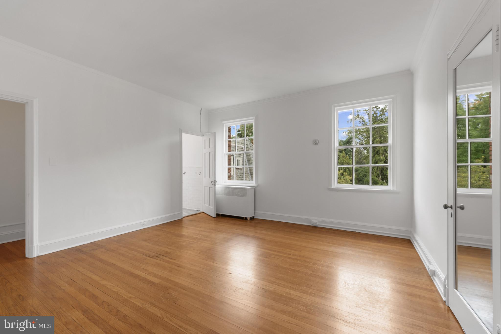 6 Upland Road, Unit F5 Baltimore, MD 21210 - Photo 25 of 31 an empty room with wooden floor and windows