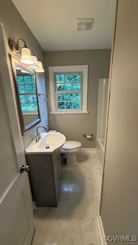 a bathroom with a sink toilet and tub