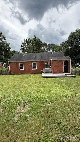 a view of a house with a yard and sitting area