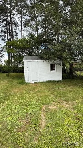 a view of a swimming pool with an outdoor seating and a forest