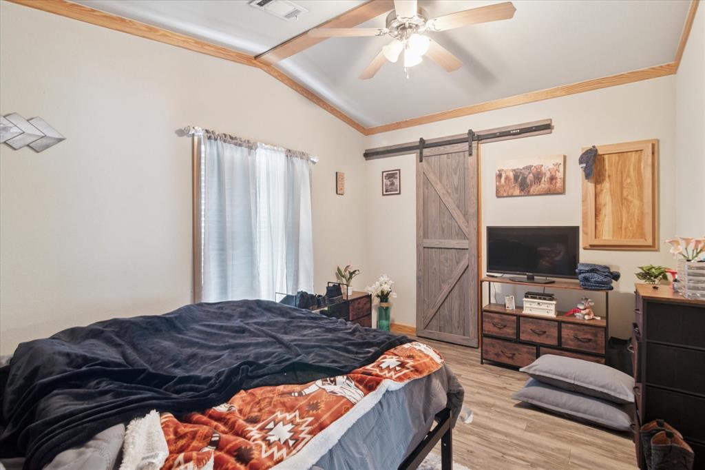 4804 Creekside Road Melissa, TX 75454 - Photo 11 of 17 a bedroom with a bed and a flat screen tv