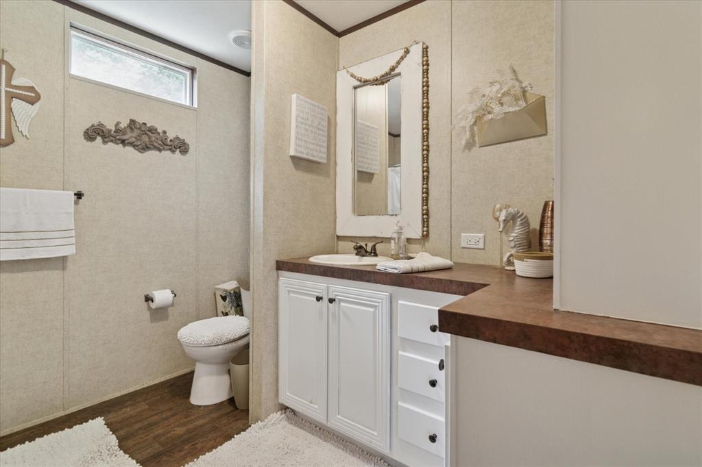 4804 Creekside Road Melissa, TX 75454 - Photo 12 of 17 a bathroom with a toilet sink and mirror