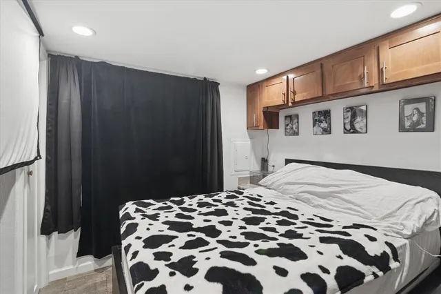 a bedroom with a large bed and a mirror