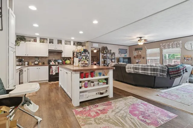 a kitchen with stainless steel appliances kitchen island granite countertop a sink and cabinets