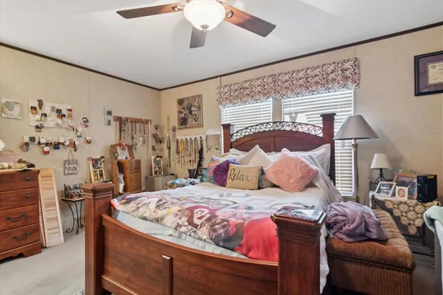 a bedroom with a bed and ceiling fan