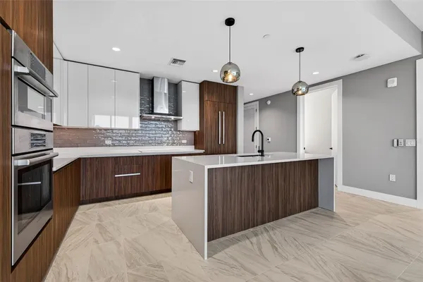 a kitchen with a sink cabinets and stainless steel appliances
