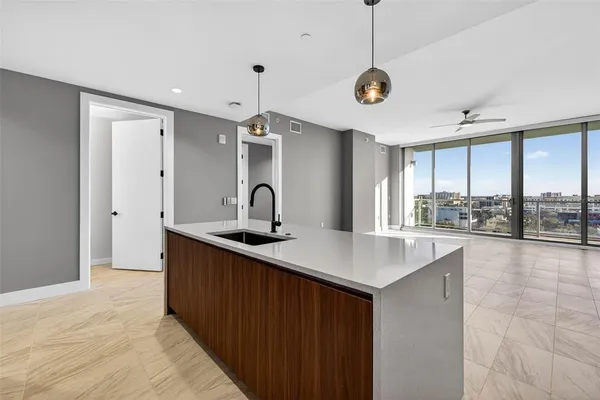 a kitchen with stainless steel appliances a sink and a large window