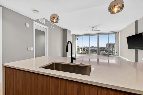 a kitchen with a sink and a refrigerator
