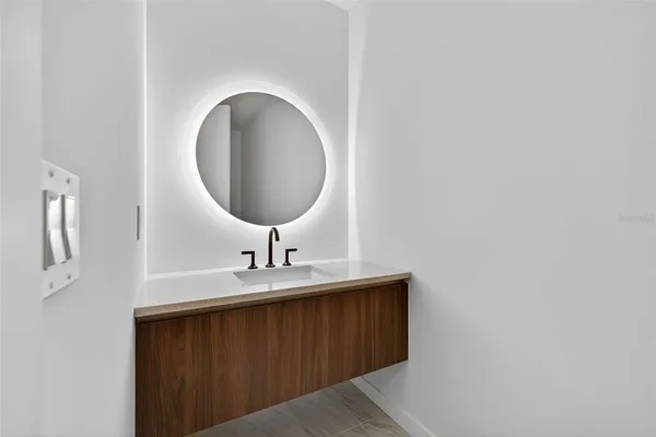 a spacious bedroom with a bed and a potted plant