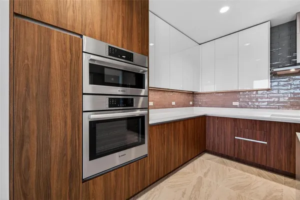 a kitchen with stainless steel appliances a stove microwave and cabinets