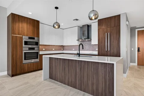 a kitchen with stainless steel appliances a refrigerator and a sink