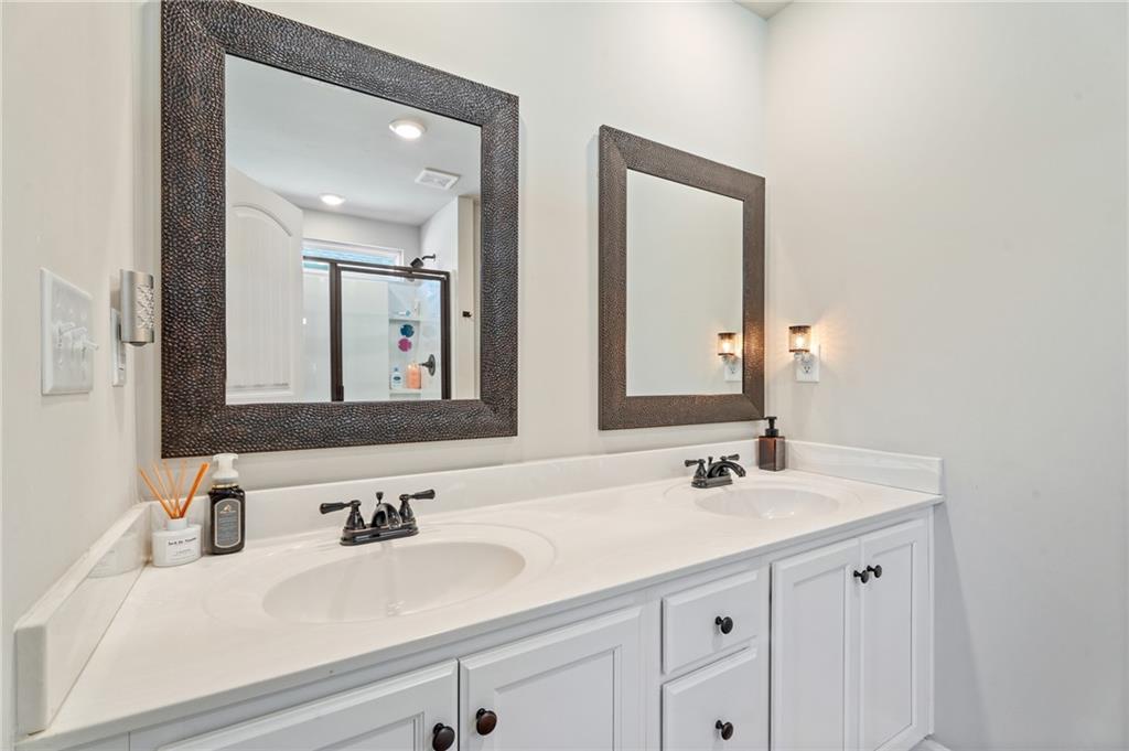 4740 Rdg Vly Drive Gainesville, GA 30504 - Photo 12 of 20 a bathroom with double vanity sinks and a mirror