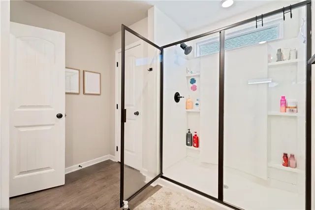 a white room with wooden floor and white walls