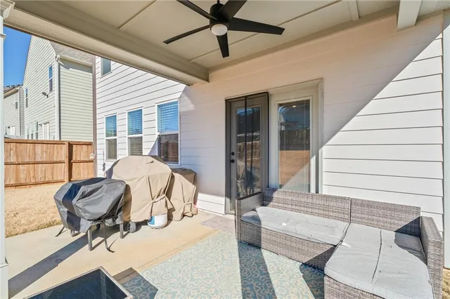a view of a livingroom with lounge chair and a large window