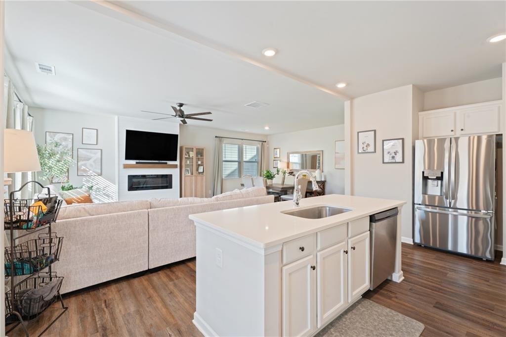 4740 Rdg Vly Drive Gainesville, GA 30504 - Photo 7 of 20 a kitchen with stainless steel appliances granite countertop a sink stove and refrigerator
